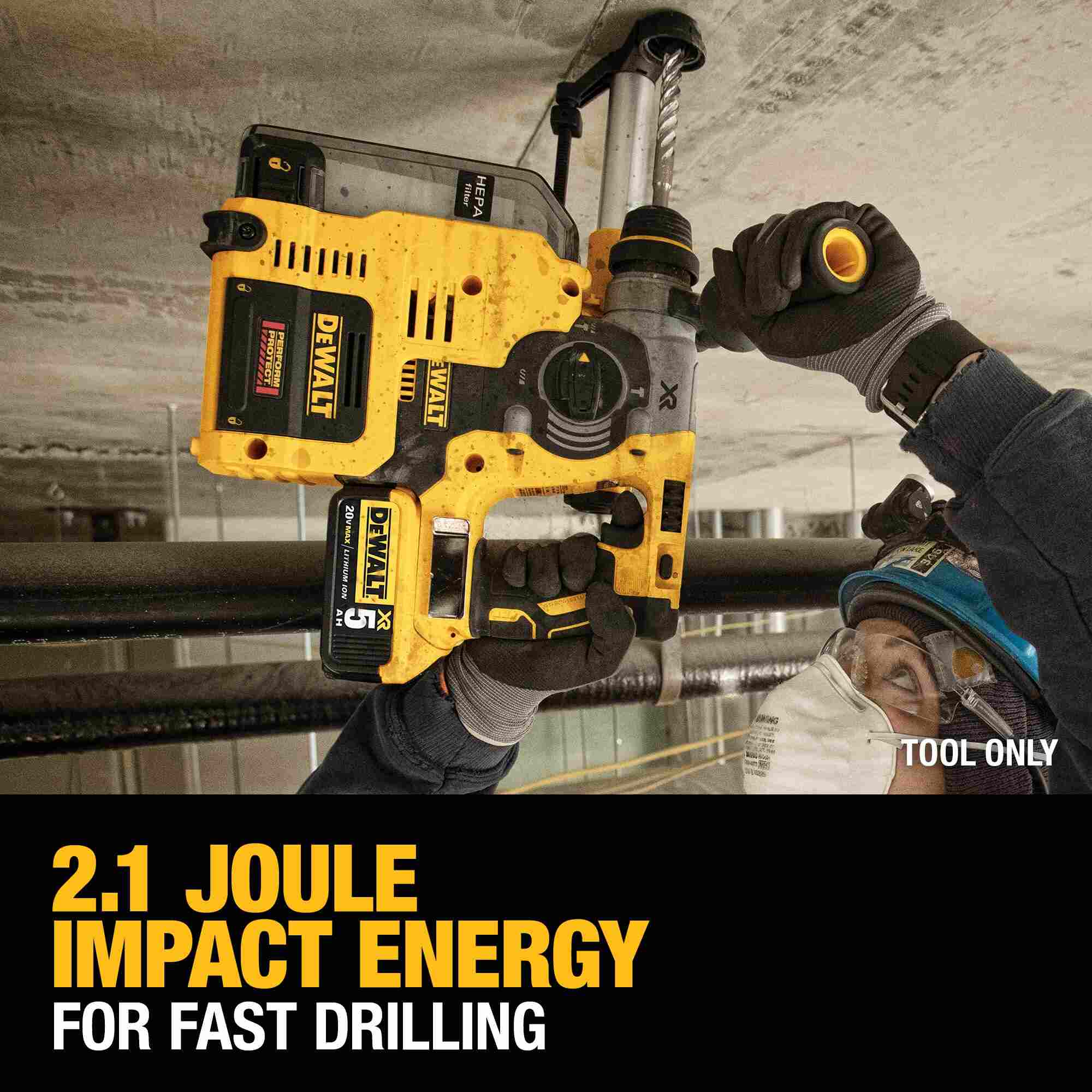 Action shot of a worker using the DEWALT 20V MAX XR brushless rotary hammer with a dust extraction system to achieve fast drilling with 2.1 Joules of impact energy.