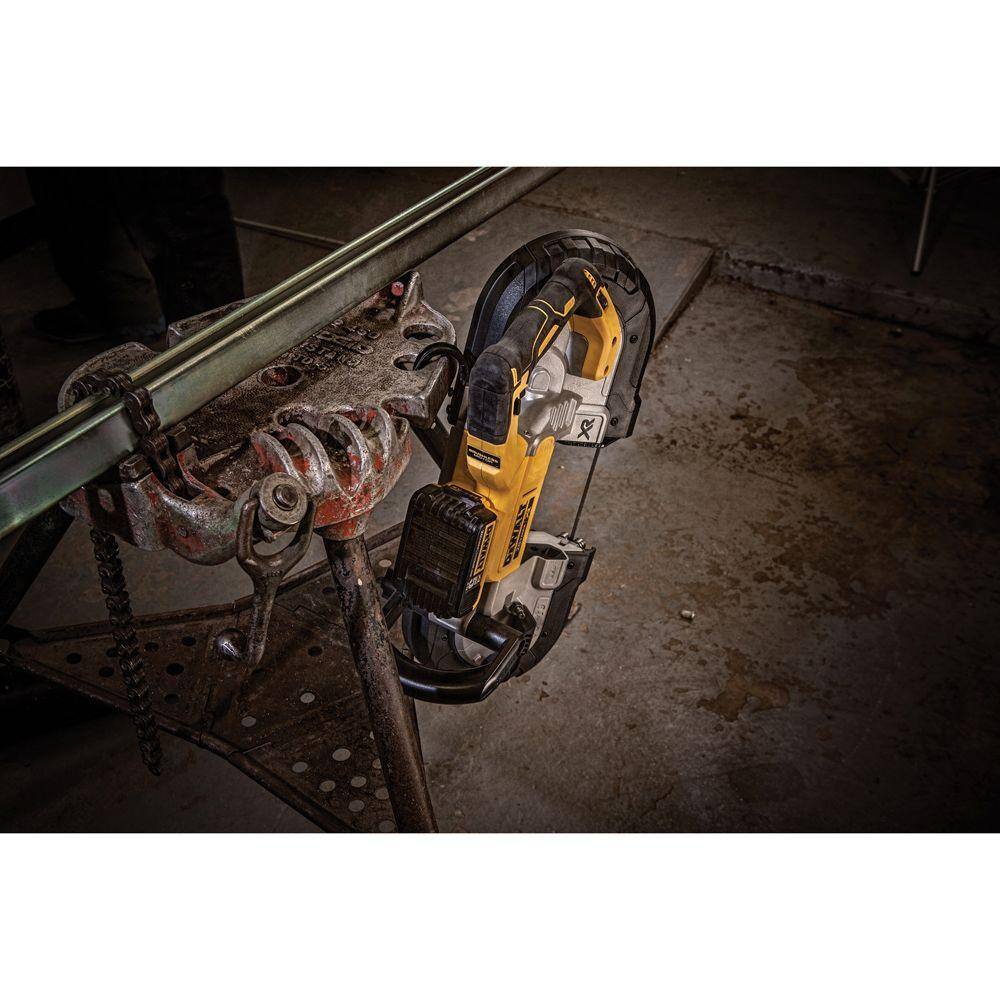 A lifestyle shot of the DEWALT DCS374B portable band saw hanging securely from a jobsite workstation using its integrated hang hook. This view highlights the tool's rugged design and the convenience of the built-in hook for protecting the saw from damage between industrial metal cutting tasks.