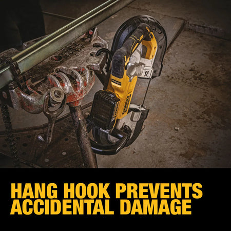A lifestyle shot focusing on the DEWALT portable band saw hanging from a metal workstation using its integrated hang hook. A text overlay states Hang Hook Prevents Accidental Damage, demonstrating how to safely store the tool off the ground between cuts.