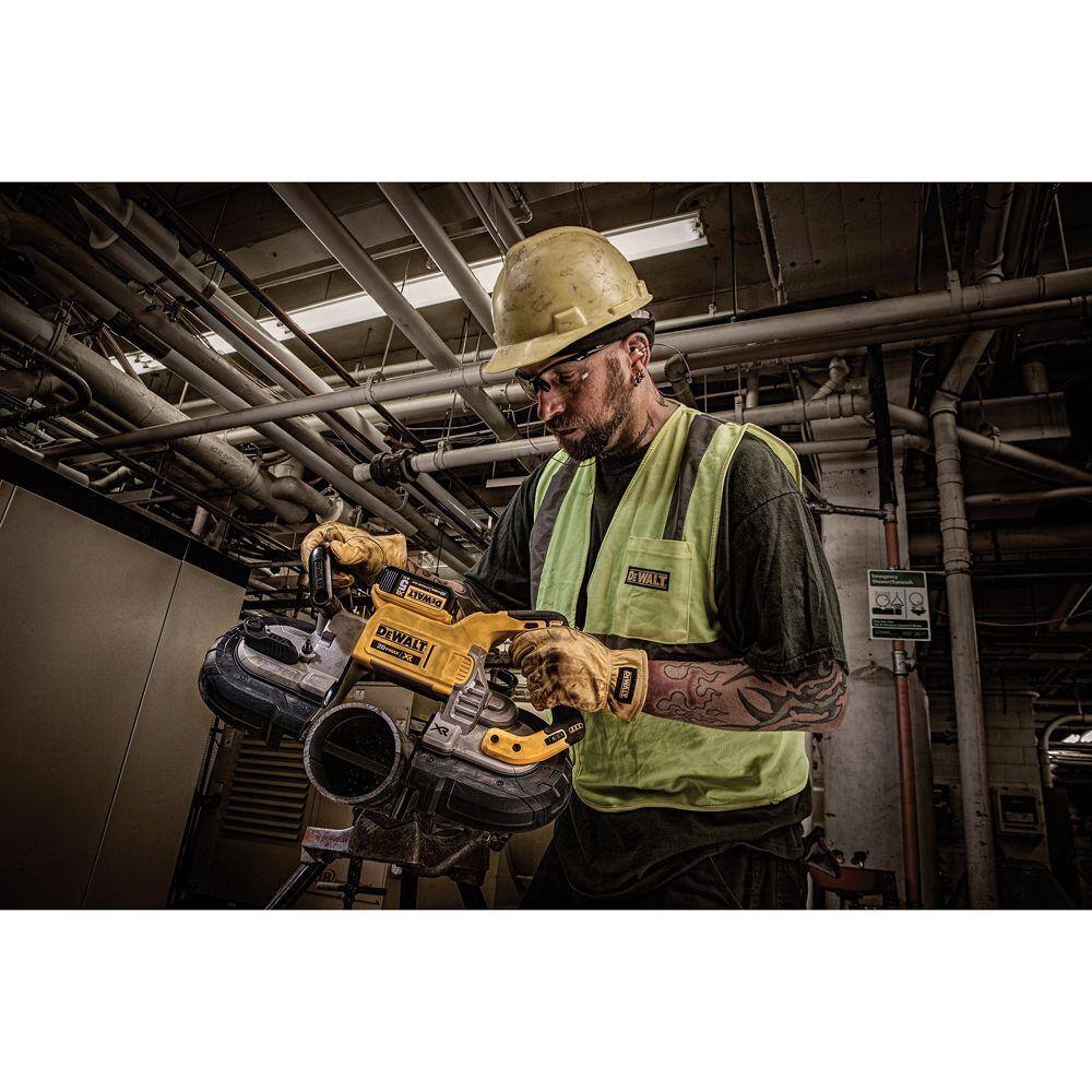 A perspective action shot of a contractor in a mechanical room using the DEWALT cordless band saw. The technician is making a horizontal cut on a heavy-duty steel pipe, demonstrating the saw's balanced weight and the efficiency of the brushless motor during industrial plumbing tasks.