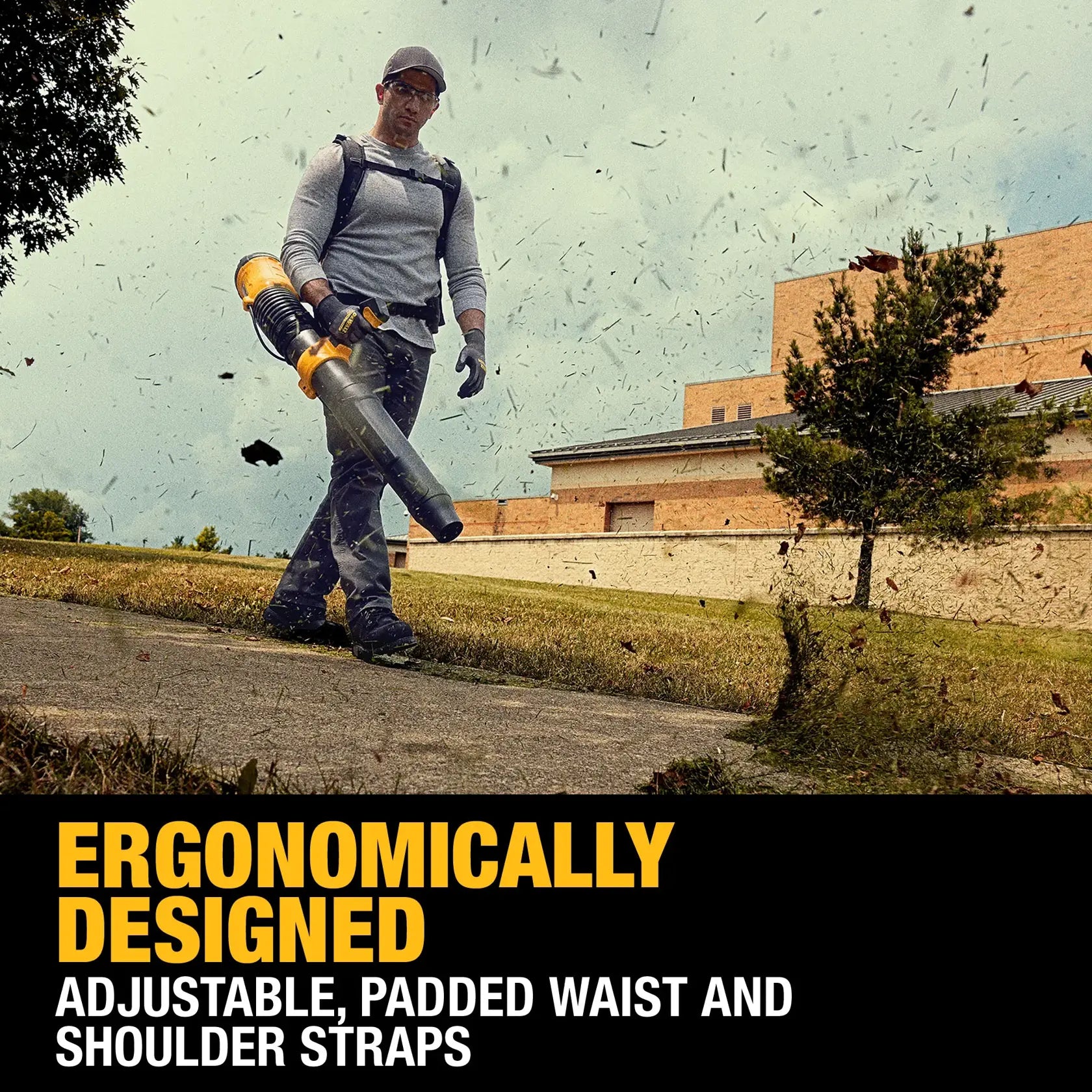 An action lifestyle shot of a professional worker using the DEWALT 60V MAX cordless backpack blower to clear grass clippings and debris from a sidewalk. The image demonstrates the tool's 855 CFM high-volume airflow and the comfort provided by the padded ergonomic shoulder straps.