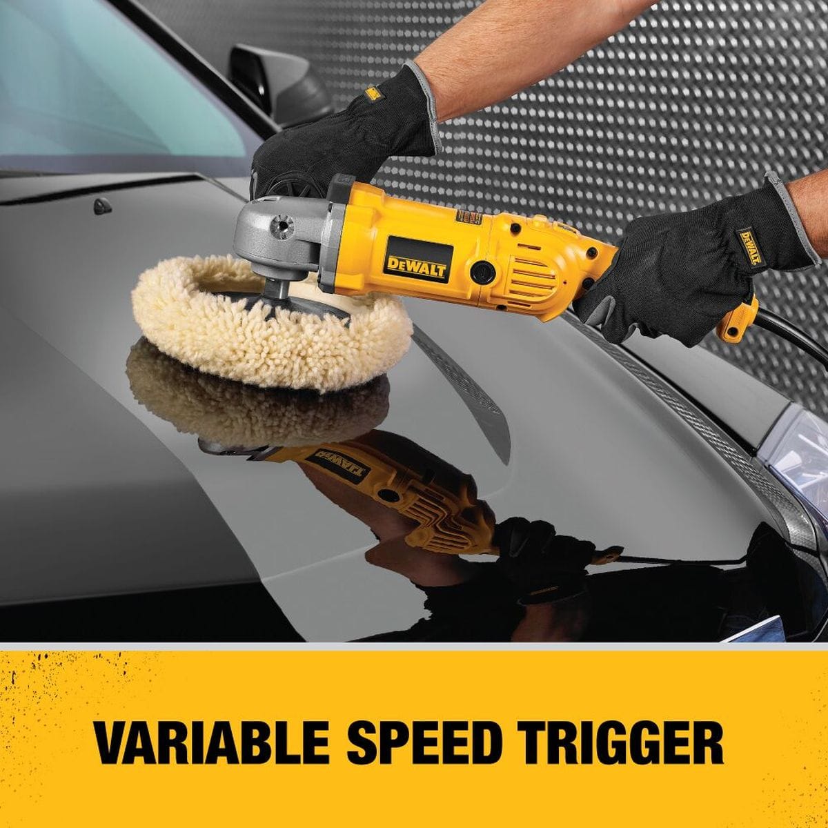 A professional detailer using the DEWALT DWP849 variable speed polisher with a wool buffing pad on a black car hood, highlighting the precision variable speed trigger.