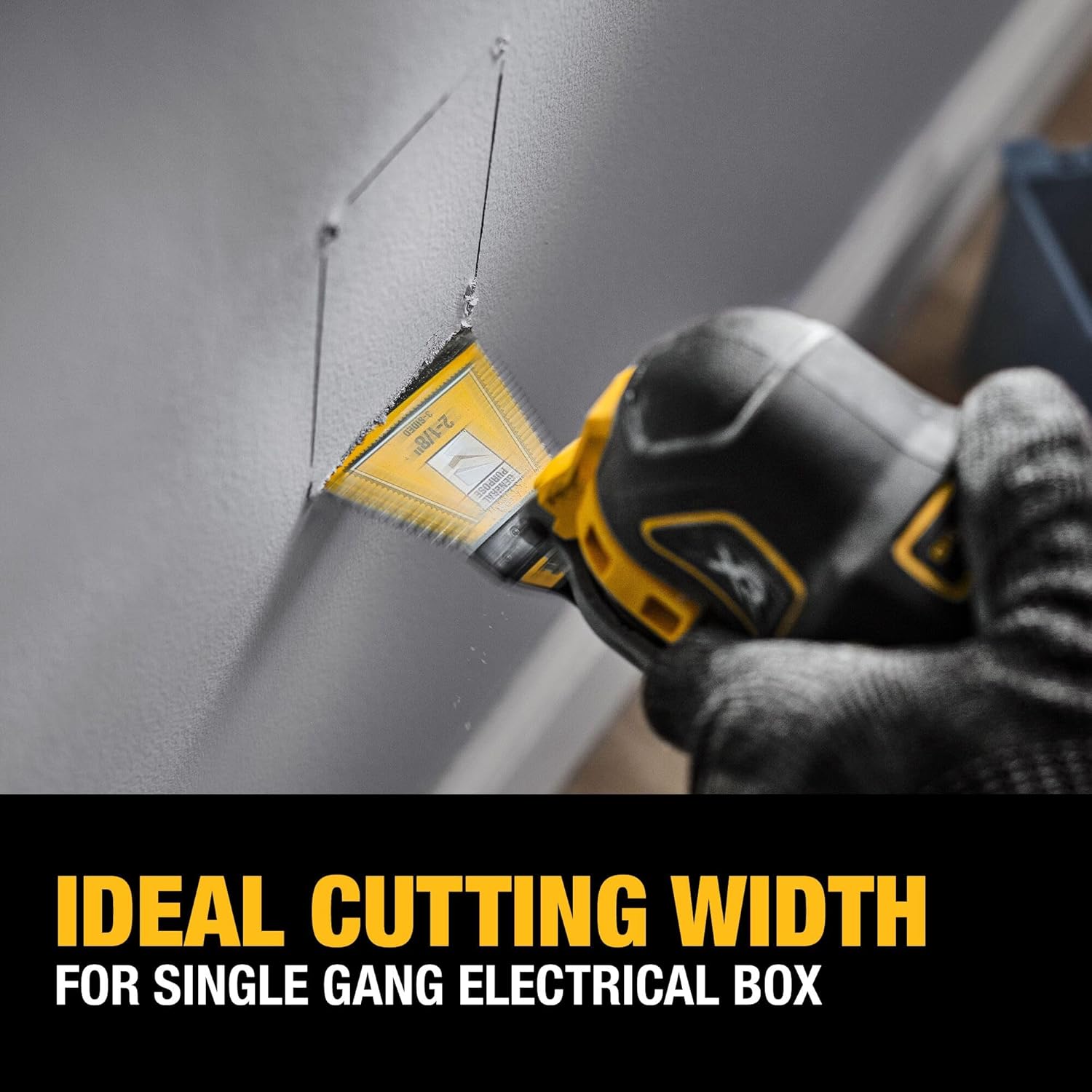 Action shot of a worker using a DEWALT 2-1/8 inch 3-sided oscillating blade to cut a precision opening for a single gang electrical box in drywall.