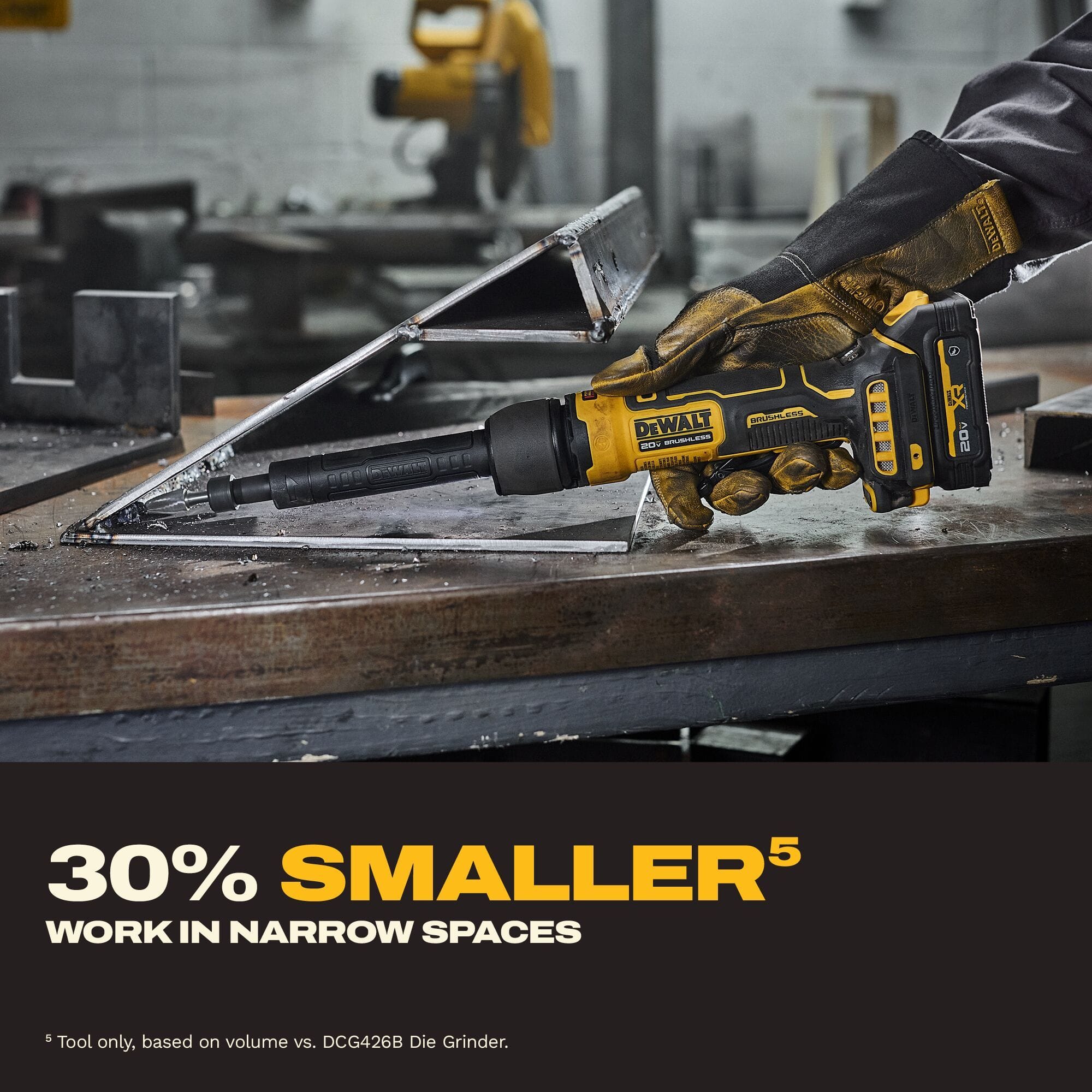 Metalworker utilizing the thirty percent smaller neck of the DEWALT ATOMIC 20V MAX extended die grinder to access and grind a narrow internal corner weld on a structural steel fabrication.