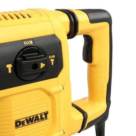 Detailed view of DEWALT rotary hammer drill grip and control dial with visible mode icons and branding.