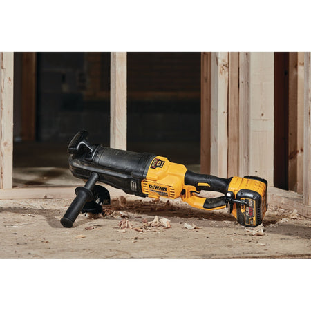 DEWALT 60V MAX brushless cordless in-line stud and joist drill resting securely on a plywood floor surrounded by wood shavings at a rough-in construction framing job site.