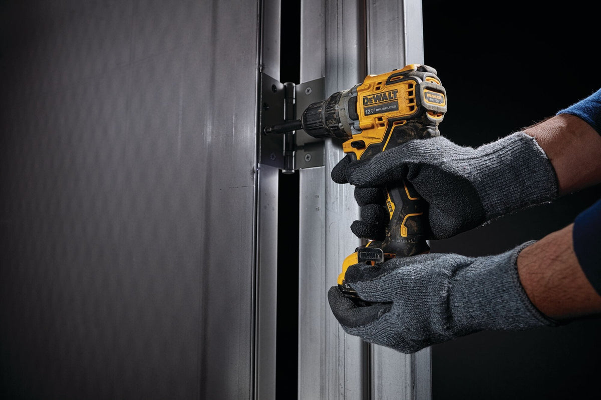 Person using a power drill on a metal door