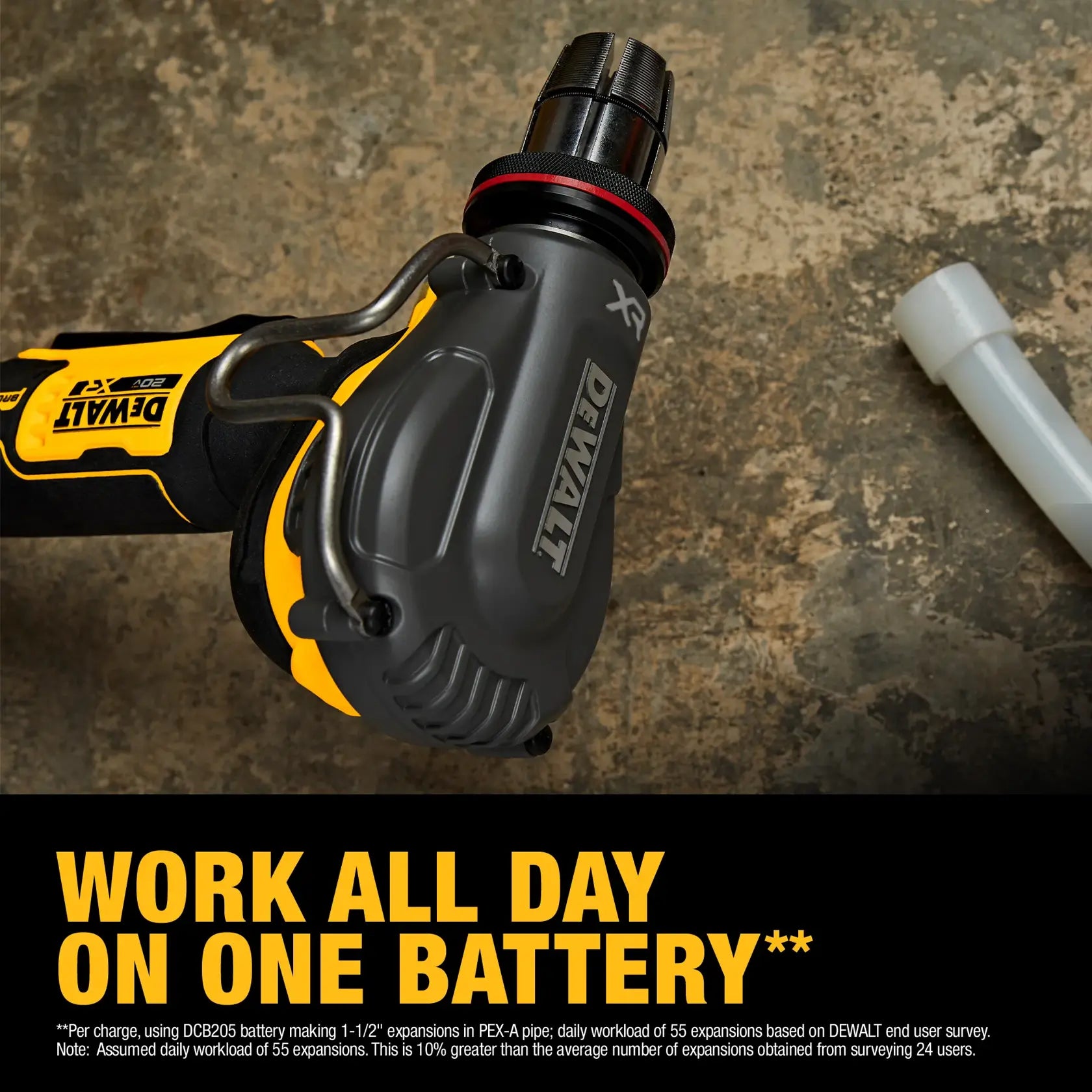 Detail shot of the DEWALT PEX expander tool resting on a job site floor, emphasizing the "work all day on one battery" performance with up to 81 expansions per charge.
