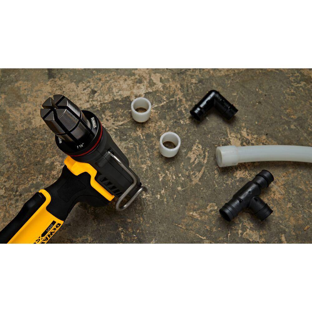 Top-down view of the DEWALT expansion head and drive cone next to various PEX-A pipe fittings and tubing components on a concrete surface.