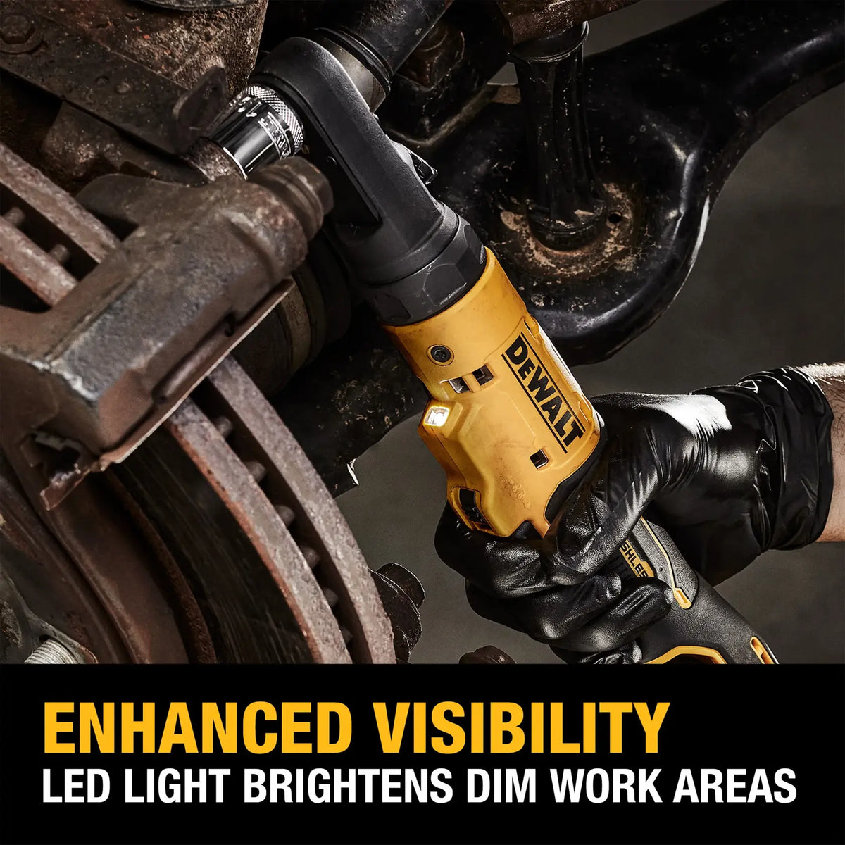 Professional mechanic in black nitrile gloves utilizing the DEWALT 12V MAX sealed head ratchet on a vehicle chassis, showcasing the bright LED worklight illuminating the workspace.