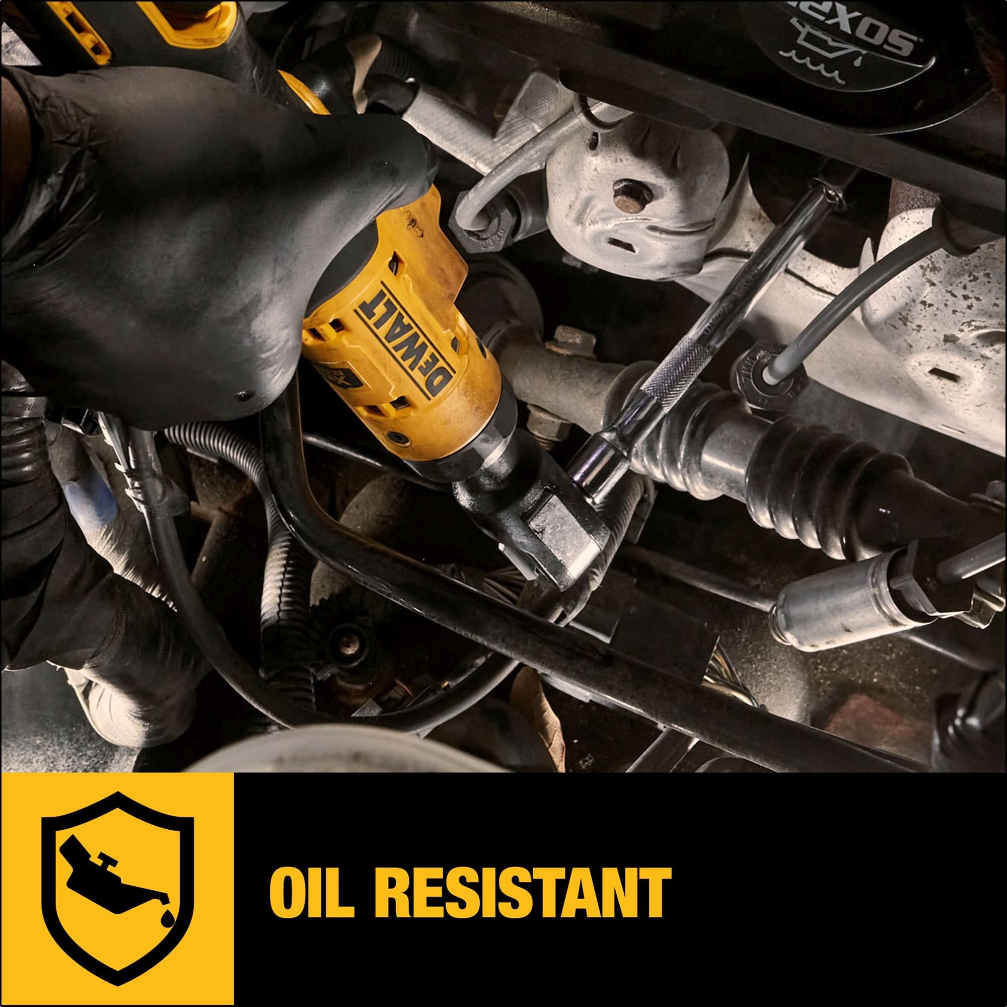Close-up of the DEWALT DCF503B cordless ratchet being used inside a complex engine bay, with a graphic overlay emphasizing the tool's oil-resistant glass-filled nylon housing.
