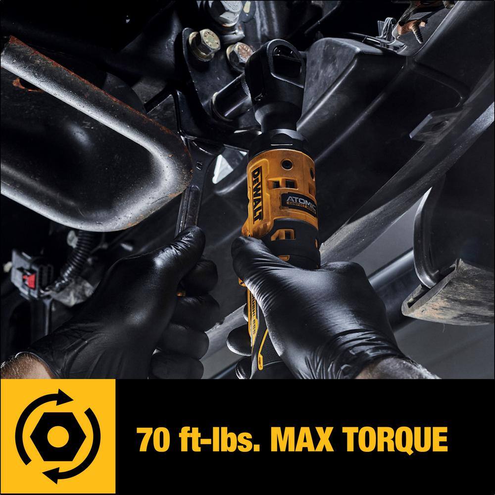 Automotive mechanic wearing black gloves using the DEWALT DCF512B ATOMIC 20V MAX cordless 1/2-inch ratchet under a vehicle, with an overlay highlighting its 70 ft-lbs of max torque.