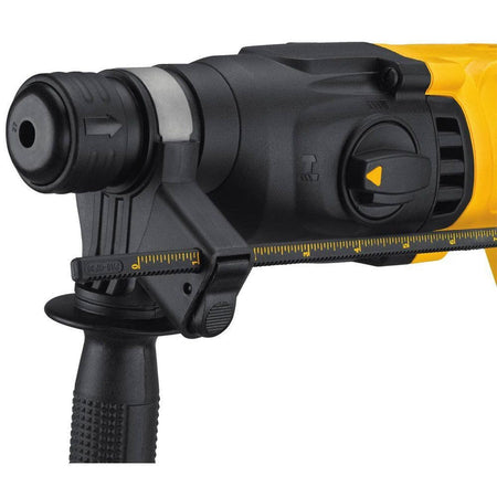 Close-up detail of the DEWALT rotary hammer's front end, showing the SDS Plus chuck, the adjustable depth rod clamp, and the mode selection dial set to hammer drill mode.