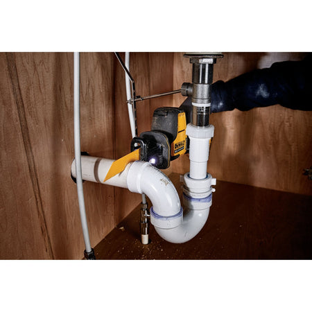 Action shot of the DEWALT DCS312 one-handed reciprocating saw performing a plunge cut through an exterior wooden door frame during demolition.