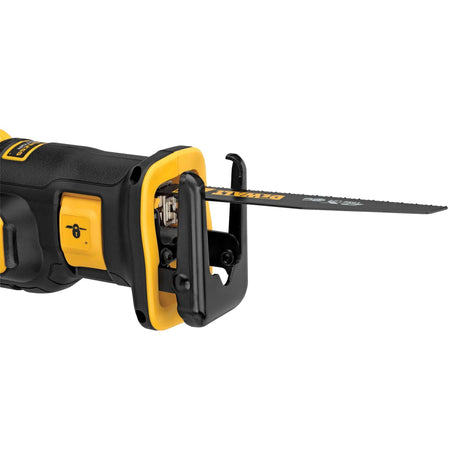 Detailed shot of a wood cutting blade being inserted into the DEWALT keyless 4-position blade clamp, illustrating the tool-free mechanism used for rapid blade changes on the jobsite.