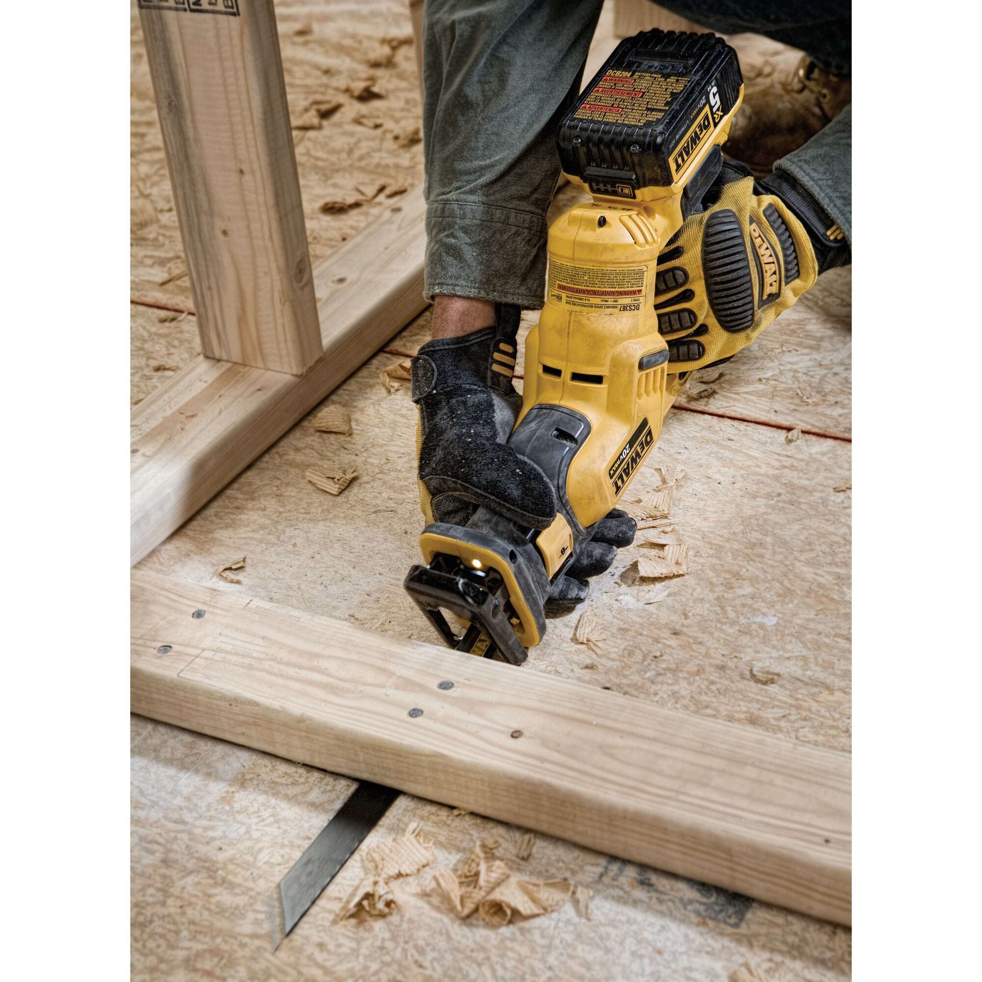 Person using a DeWalt power tool on wooden planks