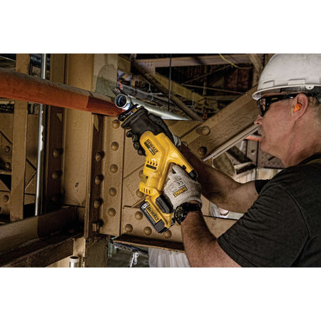 Person using a power drill on a construction site