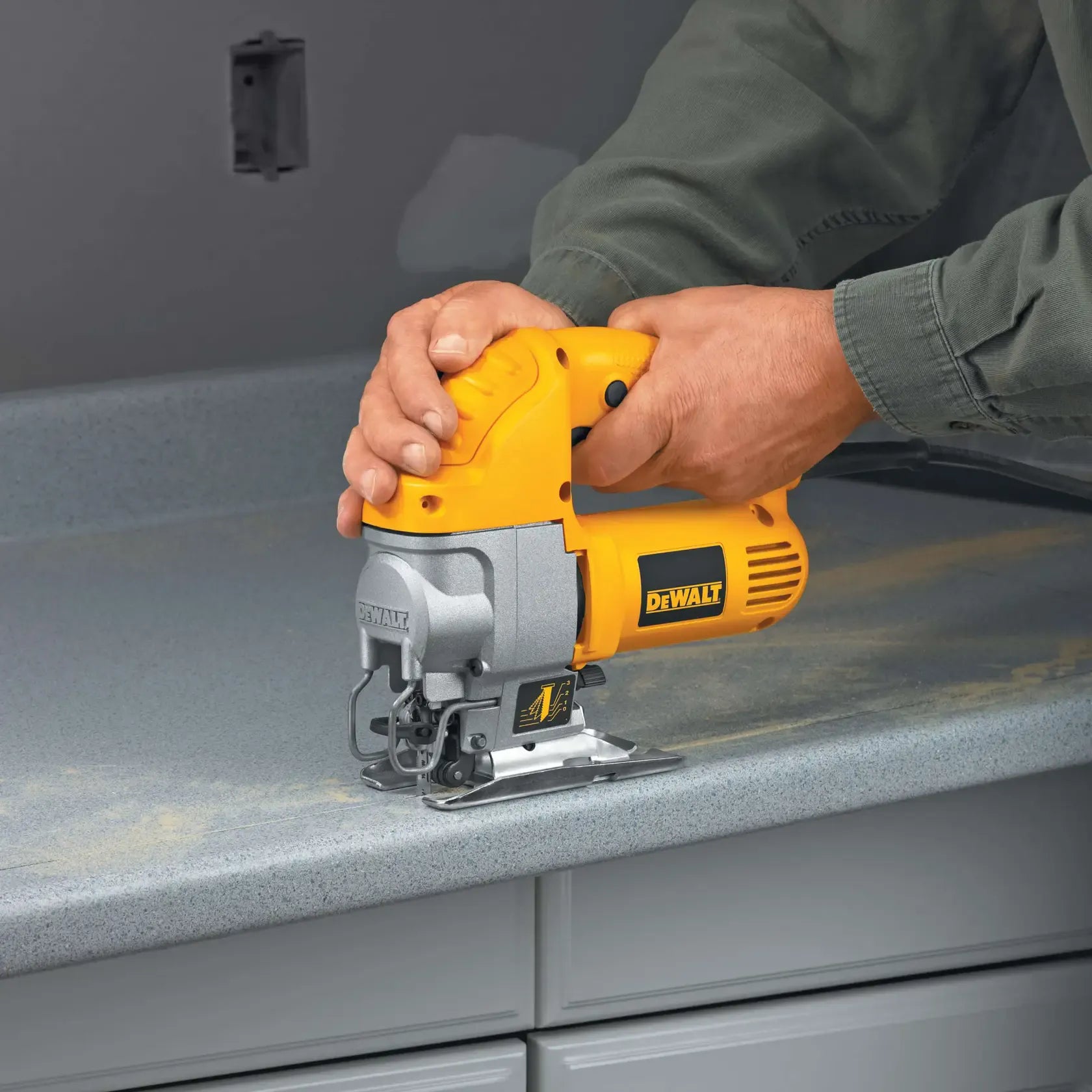 Professional installation application showing the DEWALT DW317K jig saw being used to trim a laminate countertop for a custom kitchen fit.