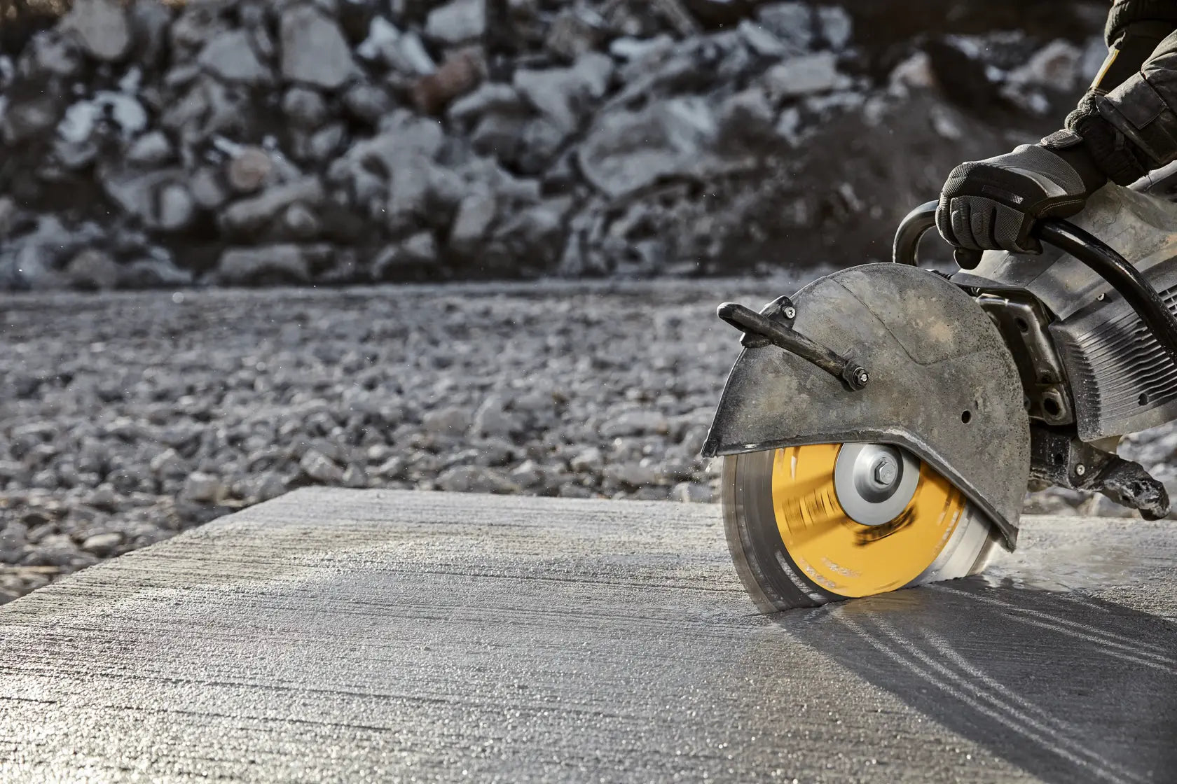 A perspective action shot of the DEWALT DW4741T blade mid-cut in a thick concrete block. The shot highlights the stability of the high-strength steel core and the efficiency of the turbo segmented rim as it maintains a straight, professional-grade path through abrasive masonry materials.