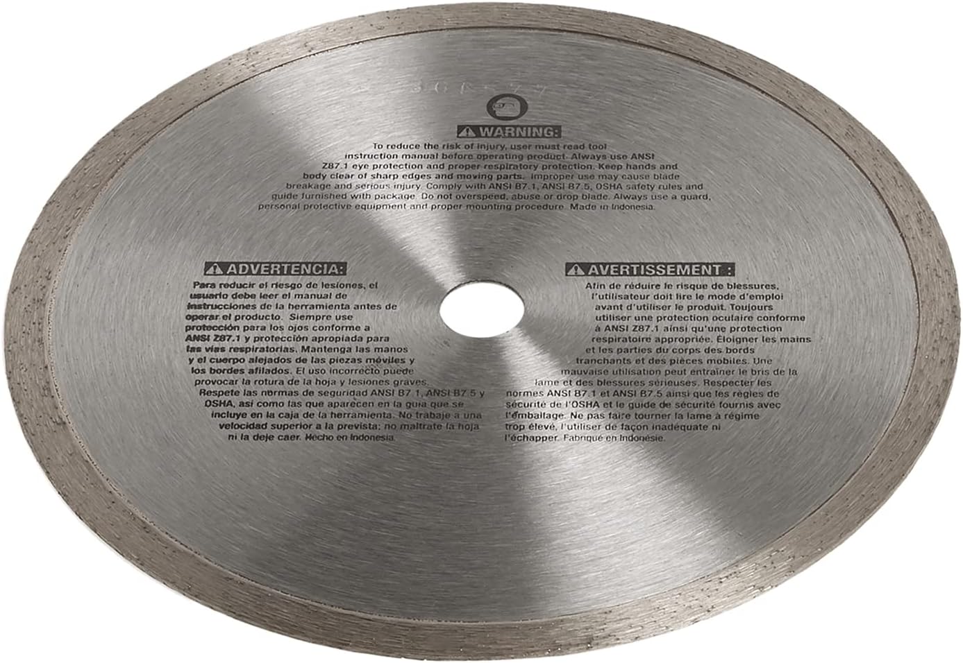 A shot of the reverse side of the DEWALT DW4791 diamond blade. The steel core is printed with detailed safety warnings and operational instructions in multiple languages, emphasizing the requirement for eye and respiratory protection during tile cutting.