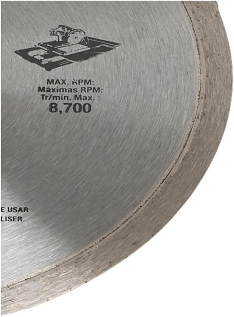 A detailed close-up shot of the cutting edge and rim of the DEWALT diamond tile blade. The focus highlights the specialized diamond matrix and the technical specification for the maximum 8,700 RPM, illustrating the blade's industrial speed and performance capabilities.