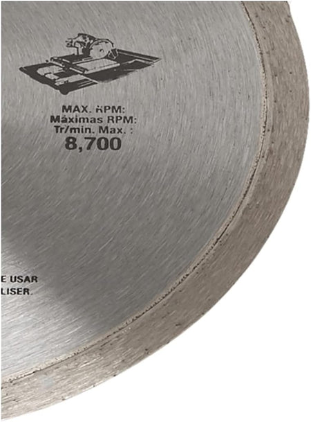 A detailed close-up shot of the cutting edge and rim of the DEWALT diamond tile blade. The focus highlights the specialized diamond matrix and the technical specification for the maximum 8,700 RPM, illustrating the blade's industrial speed and performance capabilities.