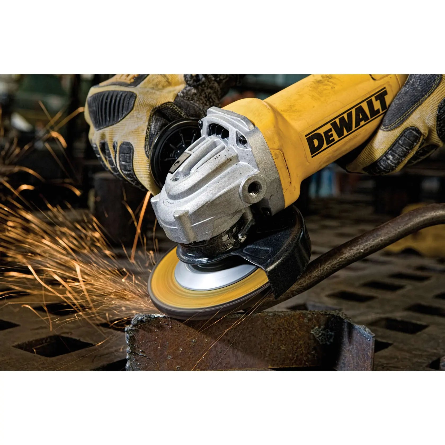 A high-intensity action shot of the DEWALT 11-Amp grinder in use on a metal fabrication project. The image emphasizes the tool's durability and power as it generates a steady stream of sparks during heavy stock removal on ferrous materials.