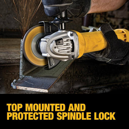 Lifestyle action shot of a professional in protective gear using the DEWALT DWE402 4.5-inch angle grinder to blend a heavy structural steel weld. The image demonstrates the tool's compact size and ergonomic paddle switch control, allowing for precise metal finishing in cramped or awkward angles.