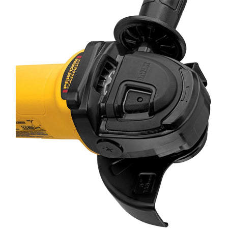 Close-up detail of the DEWALT grinder head and spindle lock, showcasing the heavy-duty metal gear case, the E-Clutch Anti-Rotation system label, and the quick-change guard lever for rapid jobsite adjustments.