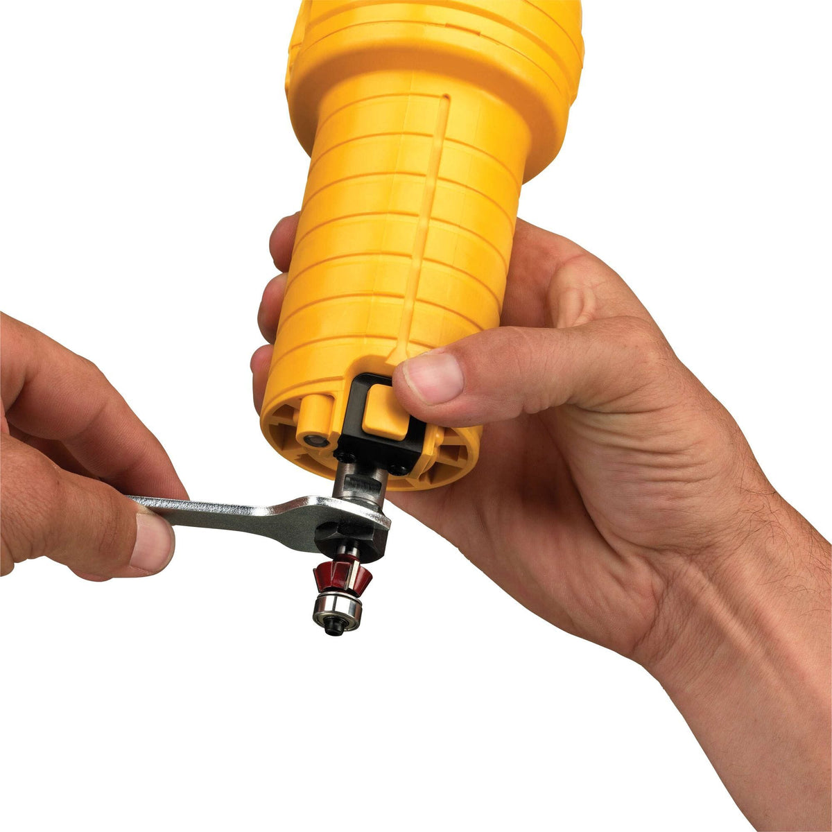 Demonstration of a bit change on the DEWALT DWE6000 Laminate Trimmer using the spindle lock button and a single collet wrench for fast and efficient tool maintenance.