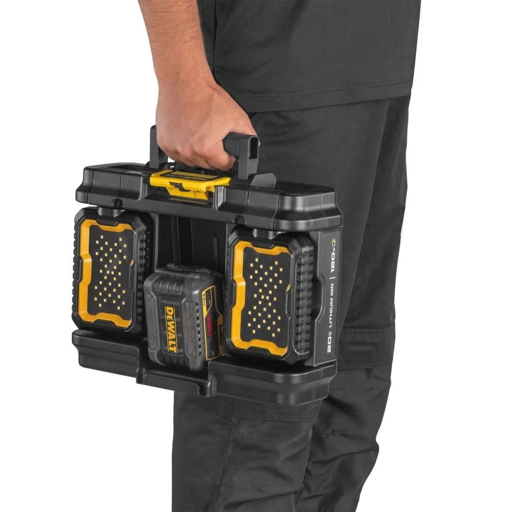 Handheld view of the DEWALT DWST08060 light box module being carried as a standalone unit, featuring a 20V MAX battery installed between the two folded LED light heads for compact transport.