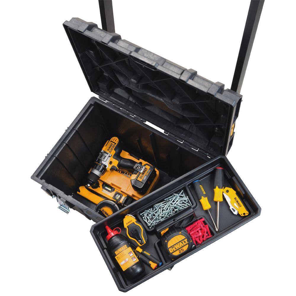 Top-down open view of the DEWALT large tool box containing a cordless drill and circular saw, with the removable inner tray organized with screwdrivers, fasteners, and a tape measure.