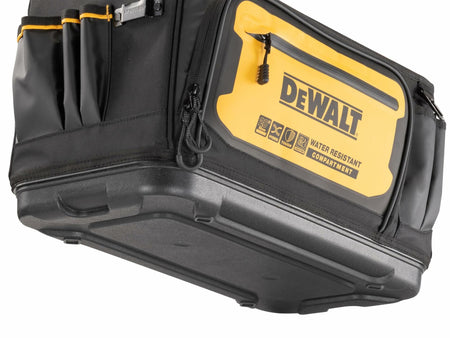 Close-up of the bottom and side of a DEWALT tool tote featuring a molded waterproof base and yellow side panel with “DEWALT WATER RESISTANT COMPARTMENT” branding. Multiple compartments and icons highlight the tote’s durability and functionality.