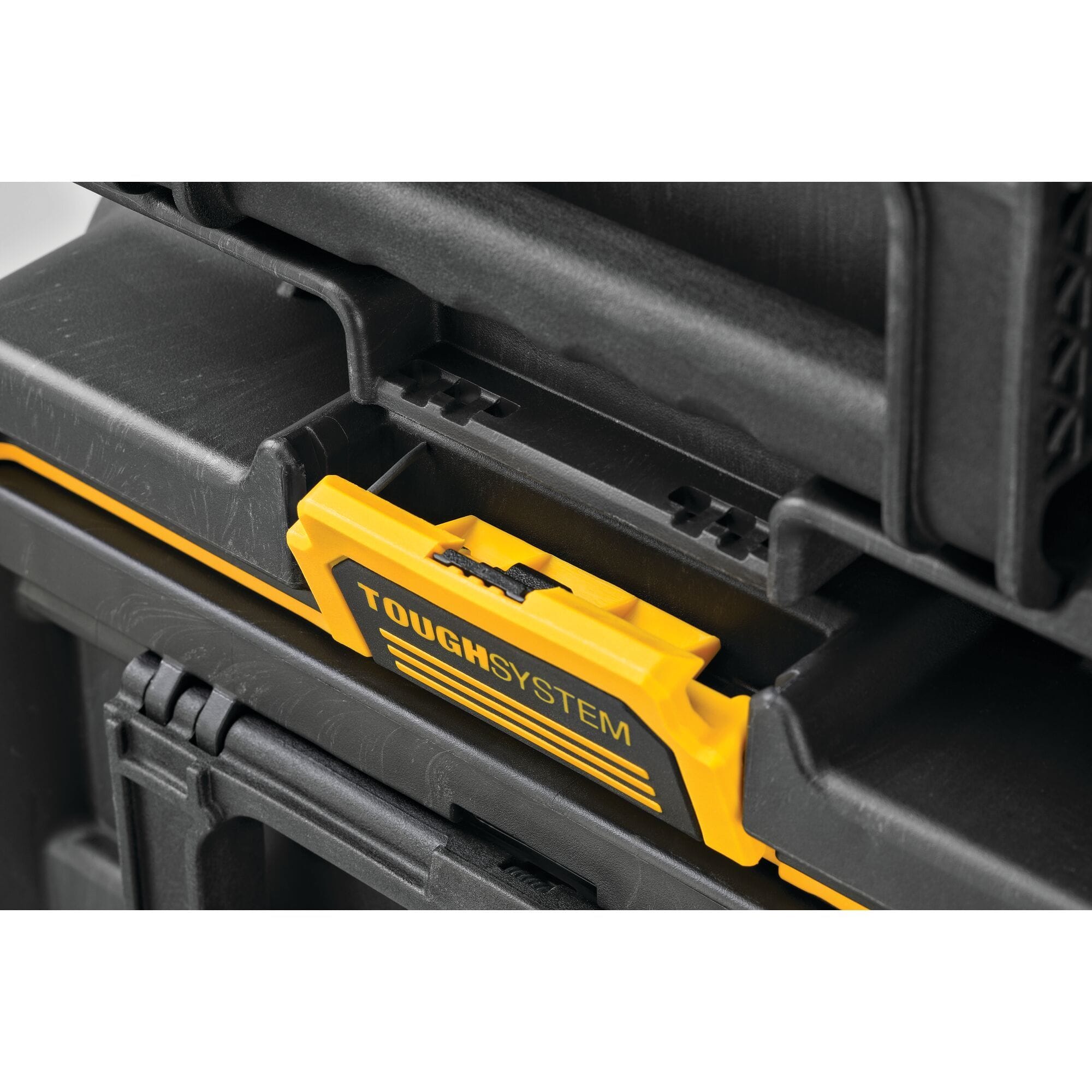 Close up of DEWALT ToughSystem latch mechanism connecting stacked tool boxes highlighting rugged interlocking modular design for secure transport and professional grade tool organization.