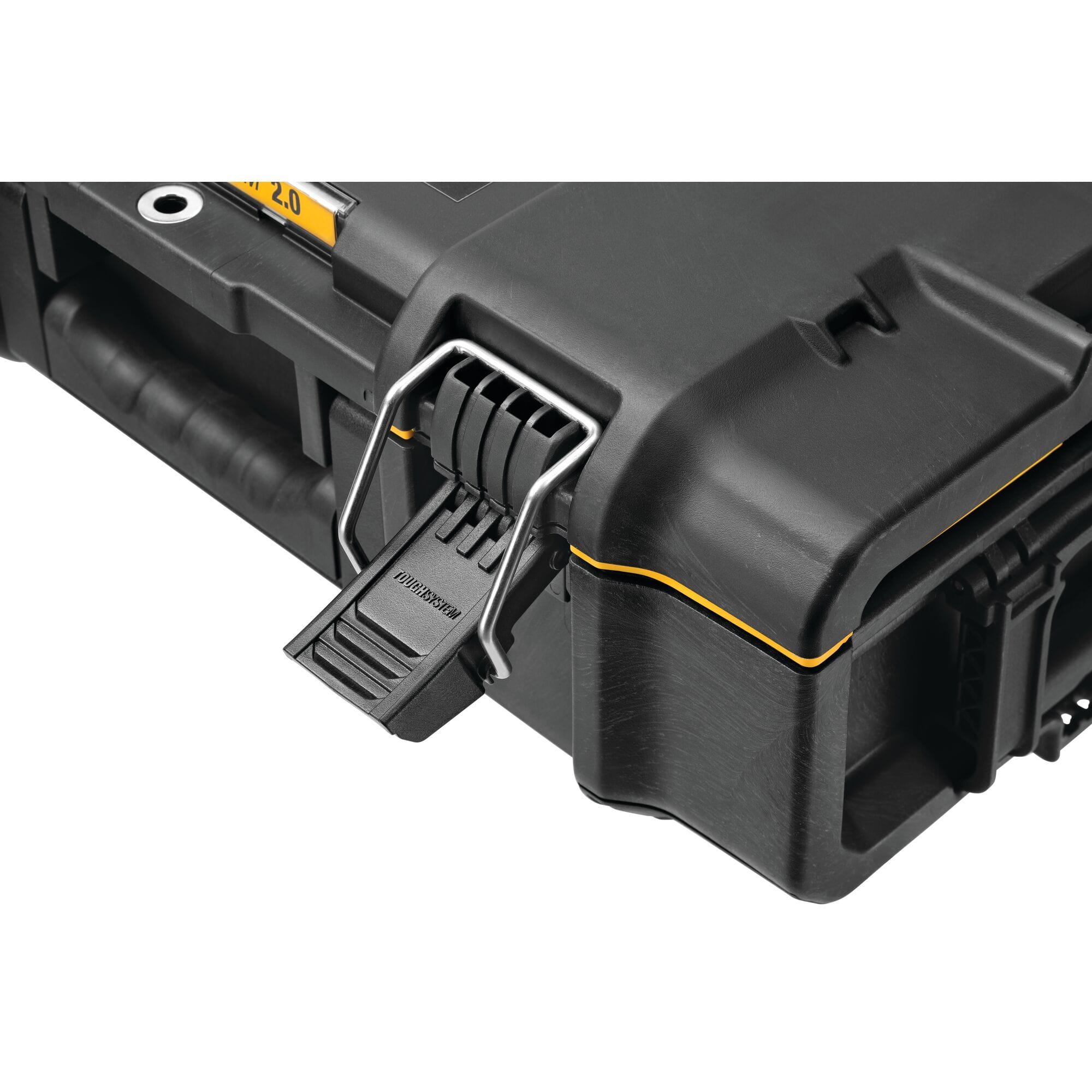 Close up of heavy duty latch on black tool storage case with TSTAK branding yellow trim and molded carry handle emphasizing durable locking system and reinforced construction.