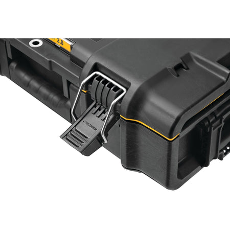 Close up of heavy duty latch on black tool storage case with TSTAK branding yellow trim and molded carry handle emphasizing durable locking system and reinforced construction.