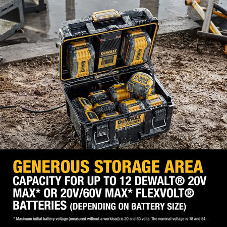 A high-angle action shot of the open DEWALT charging box sitting in muddy jobsite conditions. The image highlights the "Generous Storage Area" feature, showing the box filled with a variety of 20V MAX and FLEXVOLT batteries alongside a professional measuring tape, demonstrating its high capacity.