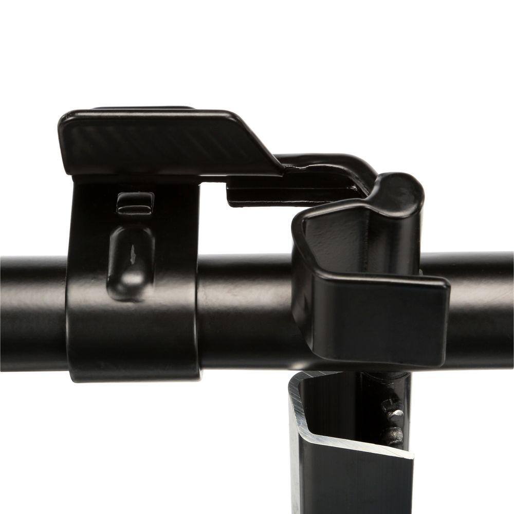 A detailed view of the central locking mechanism on the DEWALT transport rack. The image shows the heavy-duty black metal latch used to safely anchor ToughSystem cases to the carrier frame, preventing shifting during transit.