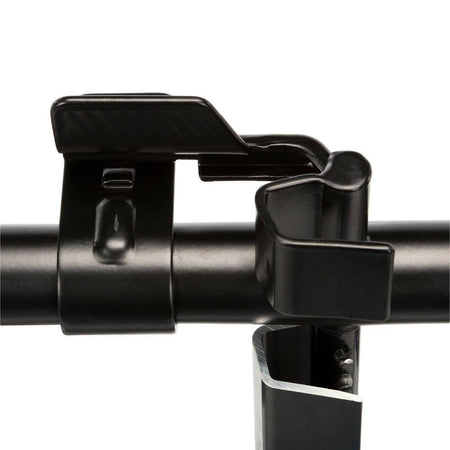 A detailed view of the central locking mechanism on the DEWALT transport rack. The image shows the heavy-duty black metal latch used to safely anchor ToughSystem cases to the carrier frame, preventing shifting during transit.
