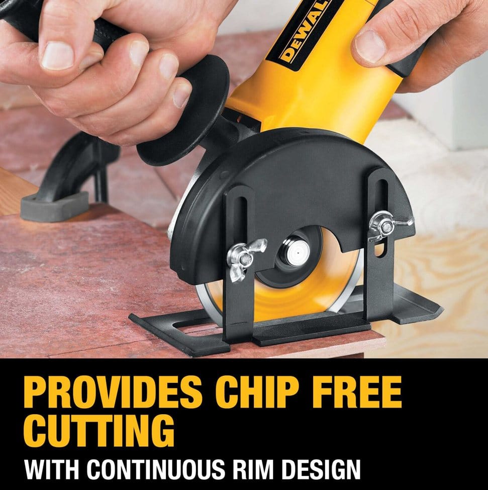 Worker using DeWALT angle grinder with continuous rim diamond blade to cut tile; clamp secures tile for precision.