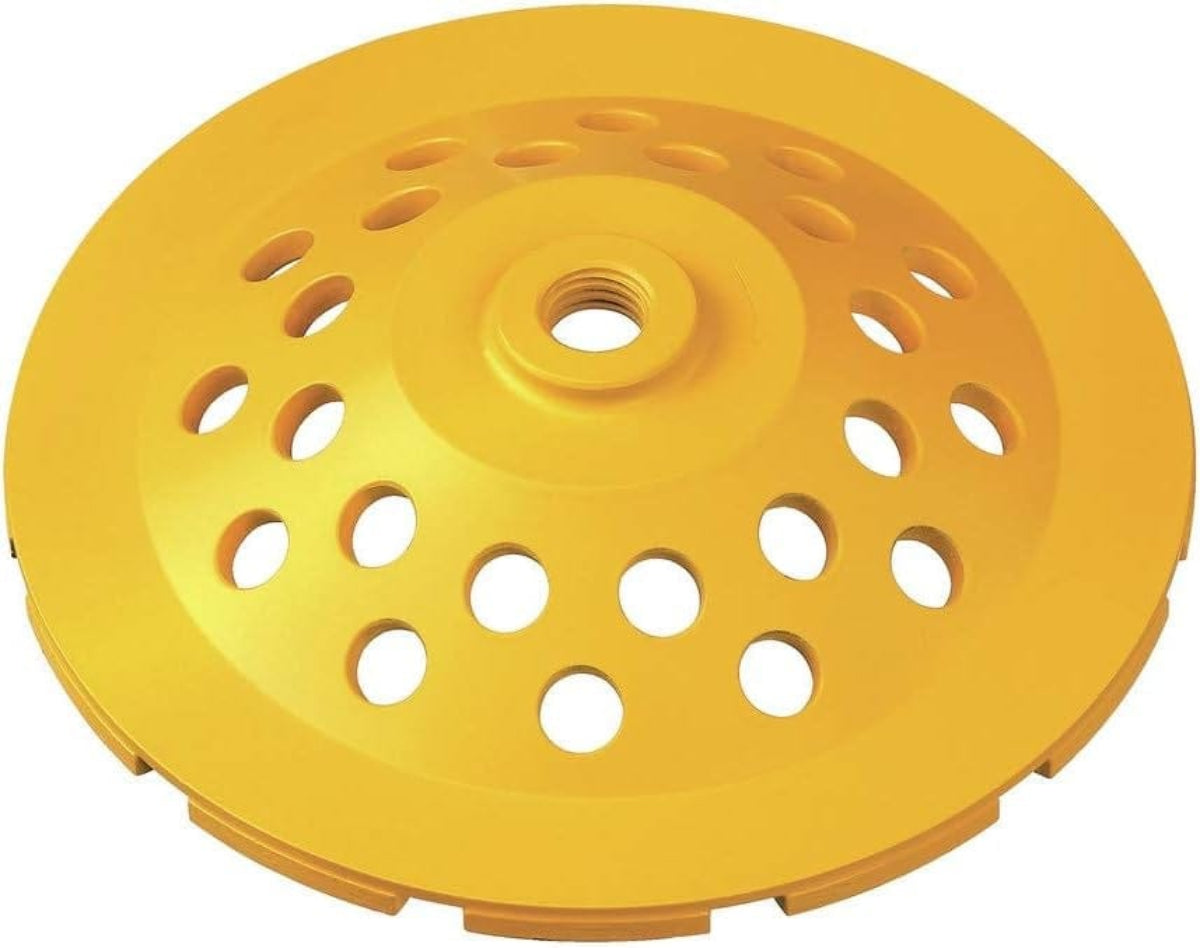 A bottom-view studio shot of the yellow DeWALT DW4773 diamond cup wheel, highlighting the 5/8-11 inch threaded arbor and the heat-treated steel body with multiple ventilation holes.