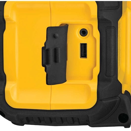 Close-up of the DeWalt Bluetooth speaker showing a USB port with a protective rubber cover. The device’s reinforced corners and textured surface highlight its jobsite durability.