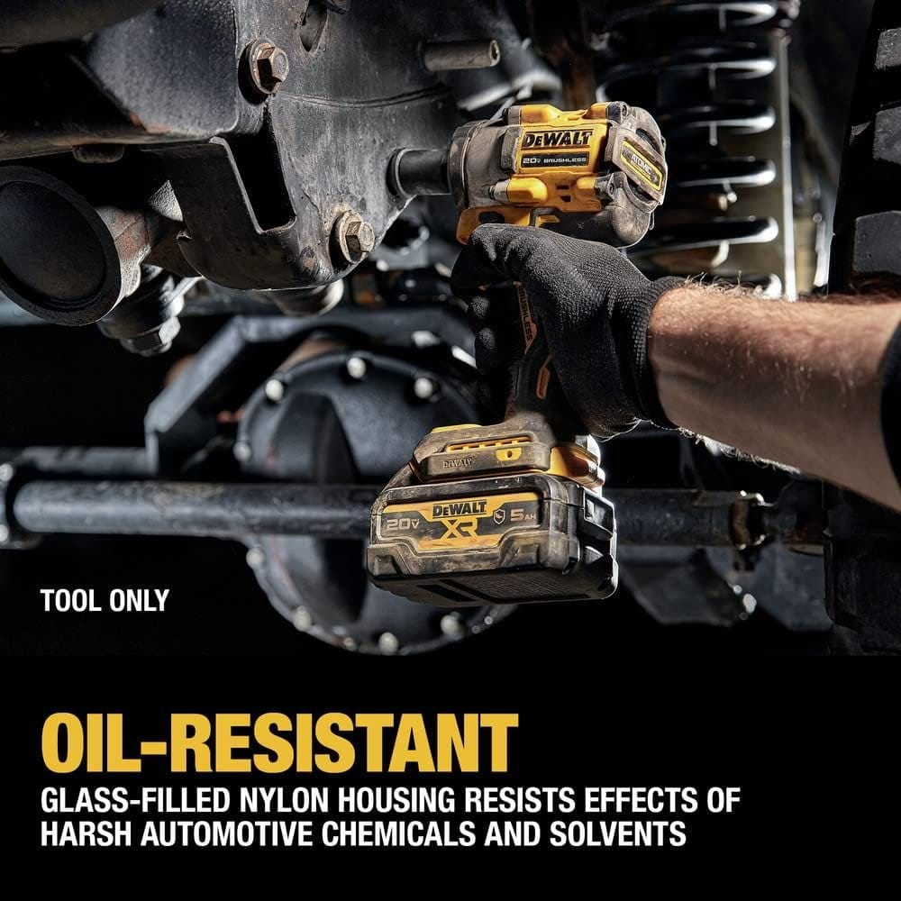 Person using DeWalt cordless impact wrench under a vehicle, highlighting oil-resistant glass-filled nylon housing suitable for harsh automotive environments