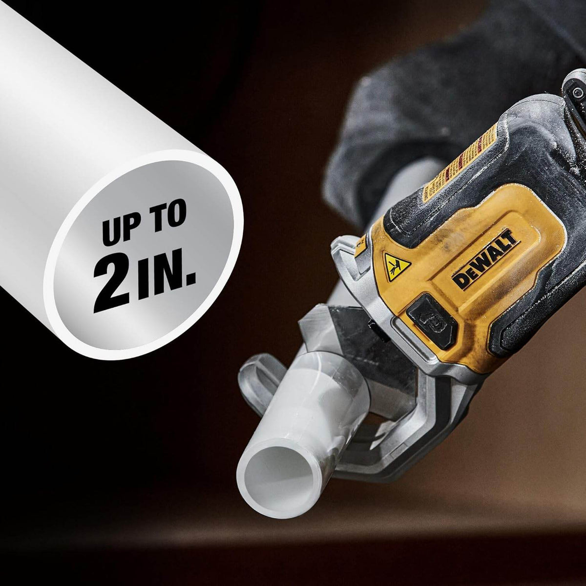 Close-up of DEWALT pipe cutter tool cutting a white plastic pipe, showing the tool’s grip and labeled “UP TO 2 IN.” for pipe diameter capacity.