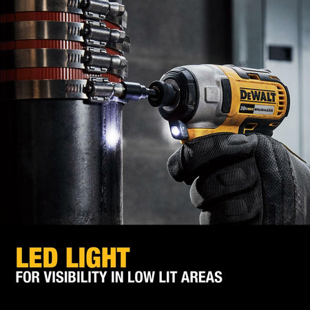 The DeWalt impact driver's LED light illuminates a dark workspace while fastening a screw. Text reads: LED LIGHT FOR VISIBILITY IN LOW LIT AREAS.