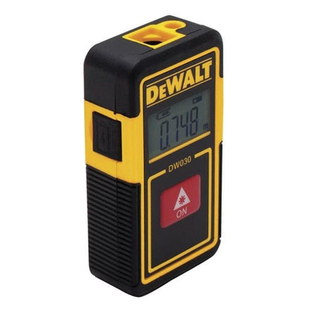 Angled view of the laser measurer highlighting the black rubber over-mold grip, the USB charging port cover on the side, and the integrated lanyard loop at the top.