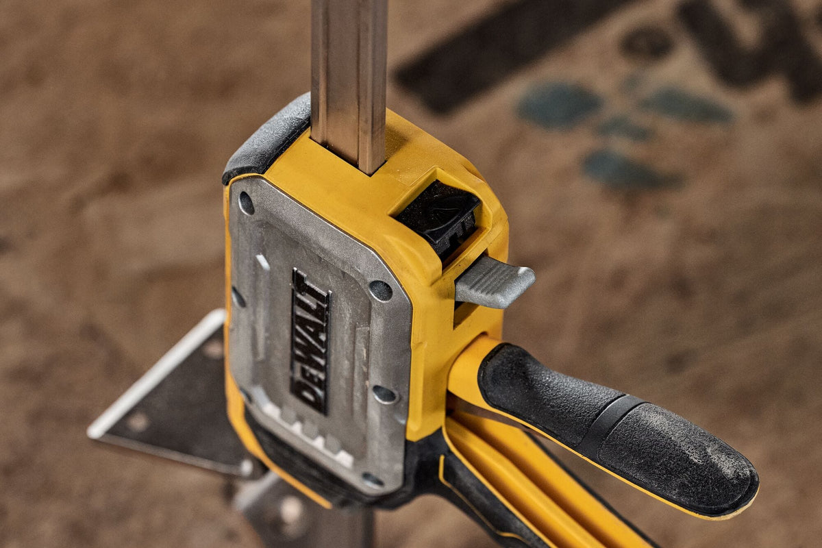 Close-up of DeWalt DWHT83550 precision controlled lowering tab used for incremental micro-adjustments under load.
