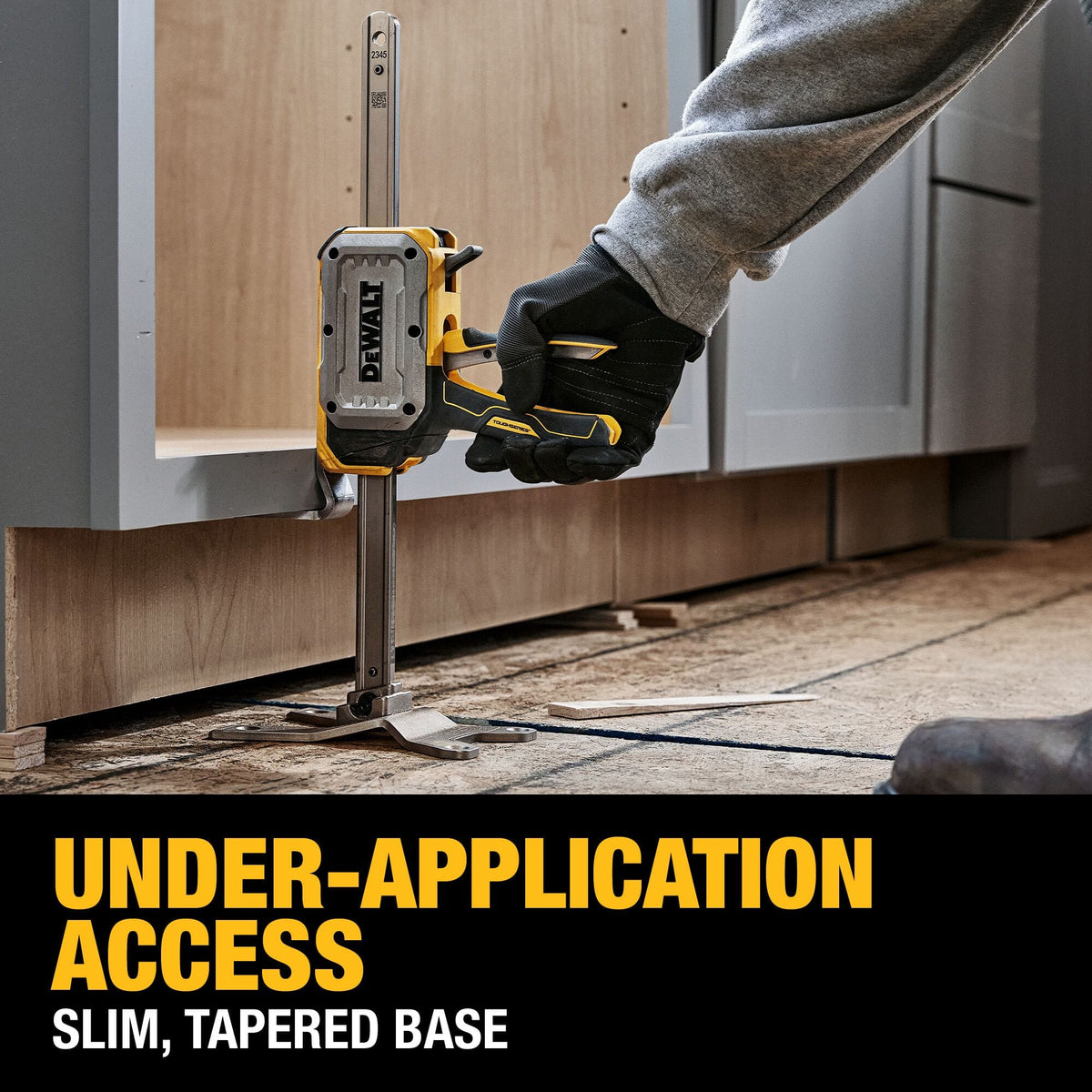 DeWalt DWHT83550 jack slim tapered toe sliding under lower cabinet frame to enable precision vertical alignment during installation.