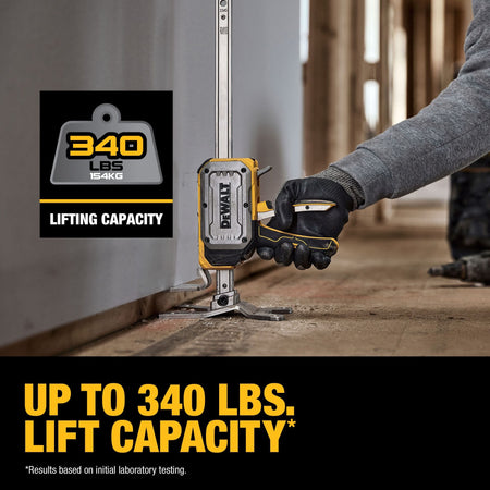 DeWalt DWHT83550 construction jack lifting heavy drywall sheet off floor using squeeze handle to provide up to 340 lbs of vertical lift.