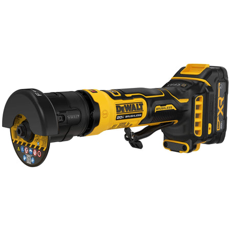 DeWalt 20V MAX ATOMIC series cordless brushless 3-inch cut-off tool shown from a front three-quarter profile perspective highlighting the attached bonded abrasive cutting wheel disc, black structural wheel guard, a yellow composite motor housing with textured rubber hand overmolds, safety paddle switch trigger, and a rear battery mounting foot isolated on a white background